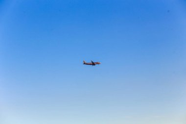 Ho Chi Minh şehrinde günbatımında mavi gökyüzünde uçan uçak