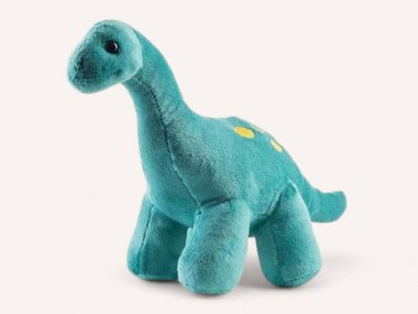 Beyaz arka planda mavi renkli peluş dinozor oyuncağı