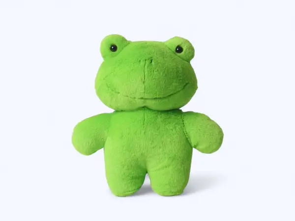 Yeşil komik kurbağa yumuşak oyuncağı arka planda duruyor