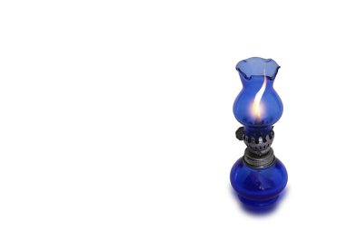 Isolated image of a blue glass lamp being lit on a white background.