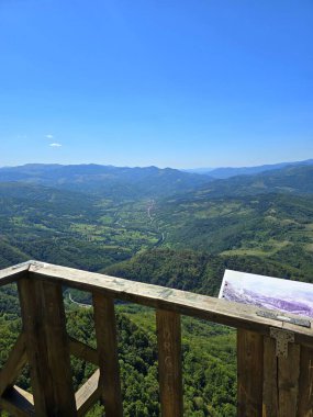 La Balcon - Wooden balcony construction on top of Bedeleu Mountain with beautiful view over nearby mountains and Aries Valley on a sunny summer day. Salciua, Alba, Romania
