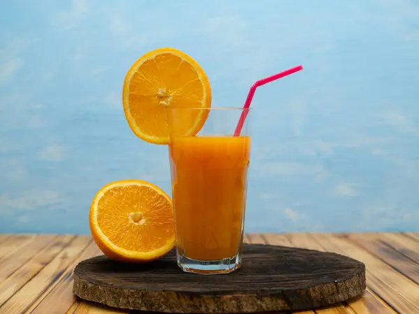 Composition of orange cut glass with juice.