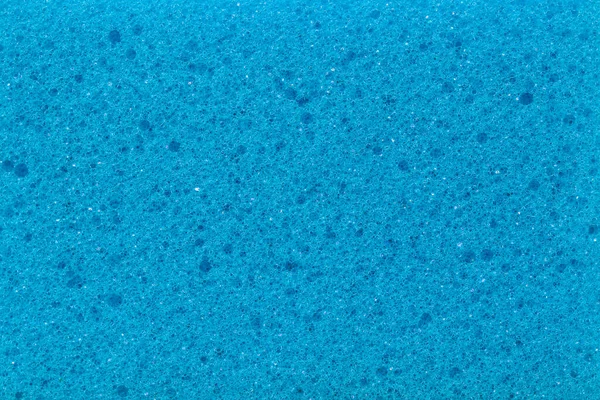 Close up on blue kitchen sponge textured background