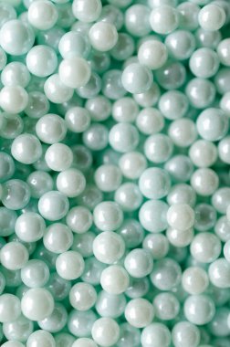 Açık mavi yenilebilir incilerin arka planı dikey biçimdeName.