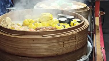 Bambu buharlı bir tencerede taze, yumuşak ve yumuşak, servis etmeye hazır, geleneksel Asya mutfağının otantik aromasını ve dokusunu yakalıyor..