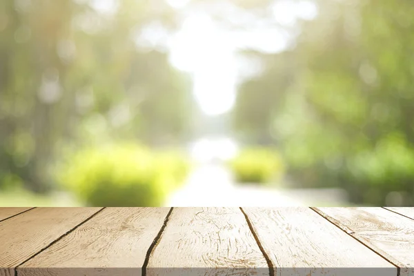 stock image Empty wooden table with Blurred image of abstract circular green bokeh from nature style background.