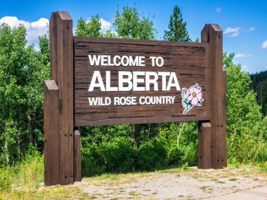 Welcome to Alberta sign near the border crossing between Waterton National Park, Canada and Glacier National Park, USA. clipart