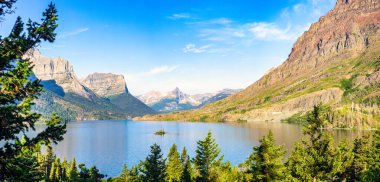 Sunrise panorama of St. Mary Lake and Wild Goose Island in Glacier National Park, Montana with Fusillade, Gunsight, Dusty Star, Little Chief and Mahtotopa Mountains in the background. clipart