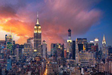 Aerial view of New York City from downtown to midtown along 5th Avenue at dusk clipart