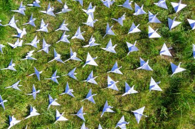 Japonlar taze çimlerin üzerinde Origami vinçlerini katladı. Yeşil alanda fotokopi alanı olan yüzlerce el yapımı kağıt kuş. 1000 bin vinç tsuru heykel konusu. Barışın, inancın, sağlığın, dileklerin ve umudun sembolü 