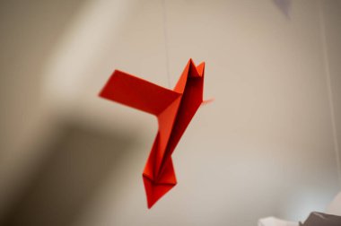 Japanese folded Origami cranes hanging on with strings. Hundreds handmade paper birds isolated with copy space. 1000 thousand crane tsuru sculpture topic. Symbol of peace, faith, health, wishes, hope