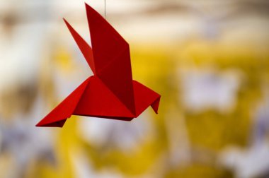 Japanese folded Origami cranes hanging on with strings. Hundreds handmade paper birds isolated with copy space. 1000 thousand crane tsuru sculpture topic. Symbol of peace, faith, health, wishes, hope
