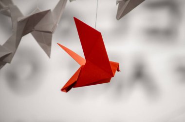 Japanese folded Origami cranes hanging on with strings. Hundreds handmade paper birds isolated with copy space. 1000 thousand crane tsuru sculpture topic. Symbol of peace, faith, health, wishes, hope