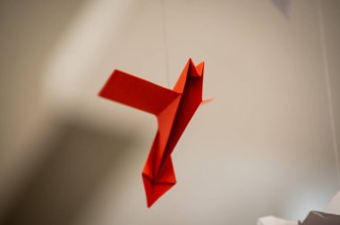 Japanese folded Origami cranes hanging on with strings. Hundreds handmade paper birds isolated with copy space. 1000 thousand crane tsuru sculpture topic. Symbol of peace, faith, health, wishes, hope