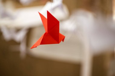 Japanese folded Origami cranes hanging on with strings. Hundreds handmade paper birds isolated with copy space. 1000 thousand crane tsuru sculpture topic. Symbol of peace, faith, health, wishes, hope