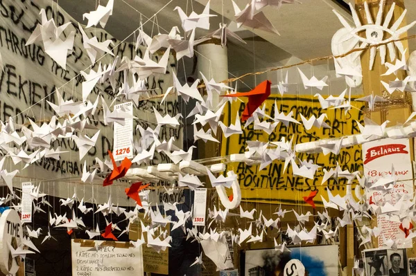 stock image Japanese folded Origami cranes hanging on with strings. Hundreds handmade paper birds isolated with copy space. 1000 thousand crane tsuru sculpture topic. Symbol of peace, faith, health, wishes, hope