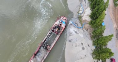 Nehir kıyısı genişliğini arttırmak için bir tarama teknesinin tepeden drone görüntüsü.