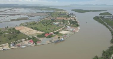 Aerial turning orbit shot revealing of the Praek Tuek Chhu River from the Gulf of Thailand. 