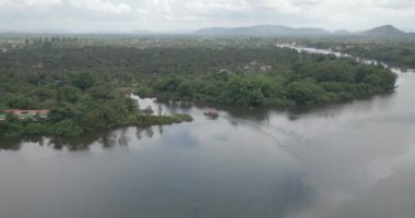 aerial panning shot of the small ferry sailing in the river 