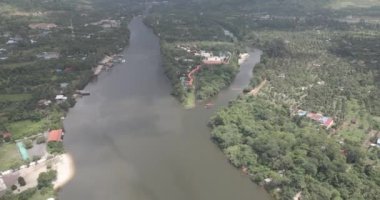 Titling down drone shot of the small ferry boat sailing on the river 