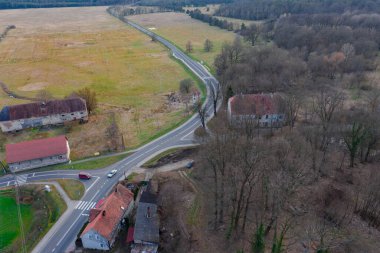 Birkaç binadan oluşan geniş, düz, kırmızı çatılar. İki asfalt yol binalar arasında kesişiyor. Fotoğraf İHA kullanılarak çekildi..
