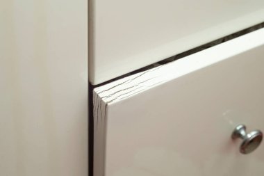 Damaged door from bathroom furniture, soft focus close up clipart