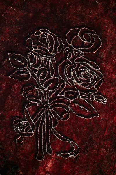 Brown velvet with rose silver outlined embroidery soft focus close up