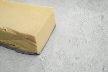 Sponge painting a wall with gray acrylic paint, soft focus close up