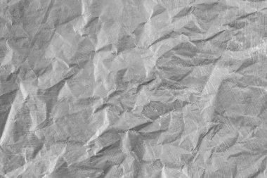 Gray painted paper, crumpled and torn, soft focus close up