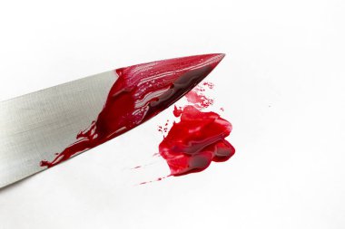 Chef knife with red blood smudge on white background, soft focus close up