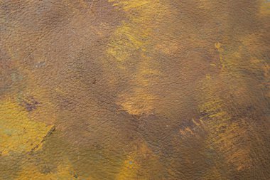 Orange and purple colors smudged on leather texture, abstract autumn backdrop,  soft focus close up.