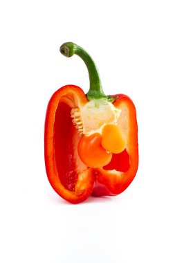 baby bell pepper inside a cross sectioned pepper, isolated on white background