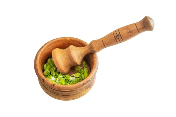 stock image Fresh, green garlic leaves paste called mujdei in romanian cuisine, made in a wood pestle mortar, soft focus close up