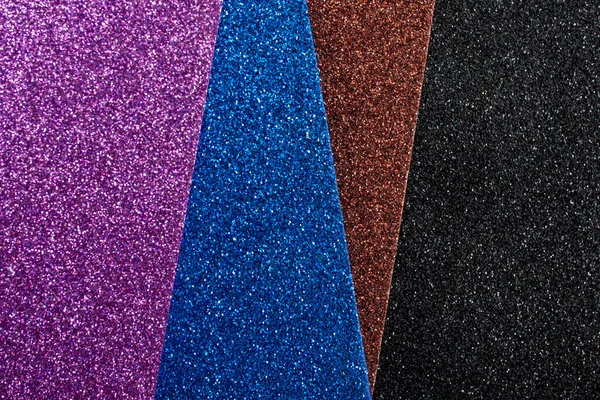 stock image violet, blue brown and black glitter sheets arranged in an angle, soft focus texture