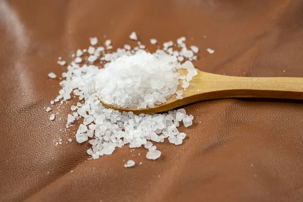 White Rock Salt Filling Wooden Teaspoon Brown Leather Skin Texture — Stock Photo, Image