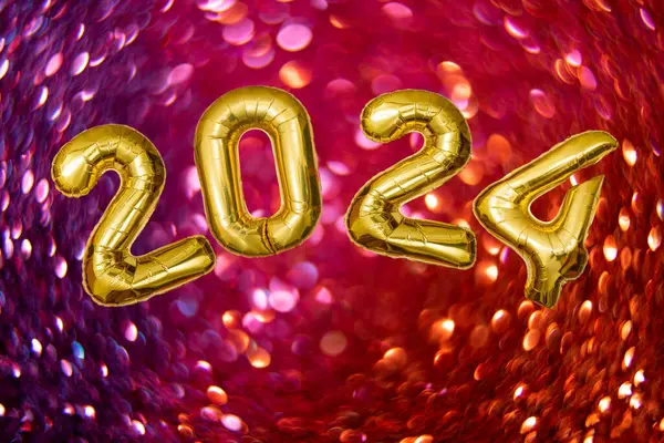 2024 tin foil balloons number on Defocused bubble bokeh abstract background. Circular bokeh of red glitter.