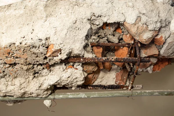 Demolition of a brick wall with iron rods rusted , abstract textures