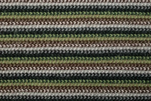 crochet fabric texture with brown, gray, green and black colored lines, abstract close up