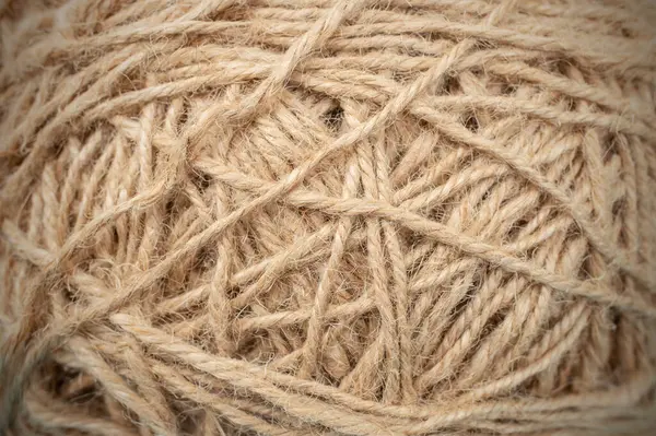 Ball or bundle of jute thread close up soft focus texture,  backdrop