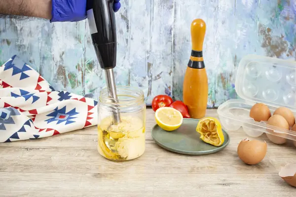 stock image Mayonnaise preparation in a glass jar with a immersion vertical blender,  close up