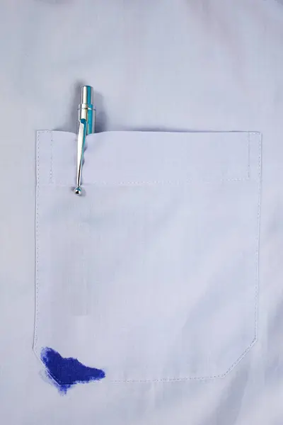 stock image Blue ink spill in a purple shirt front pocket 