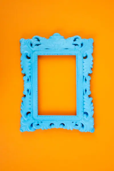 stock image Blue painted baroque frame on orange background 