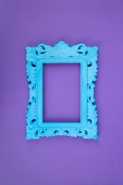 Stock image Blue painted baroque frame on purple paper background, 