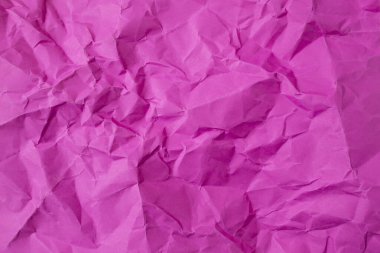 Magenta renkli kağıt, buruşuk, gölgeli kırışıklıklar, yumuşak bir odak. 