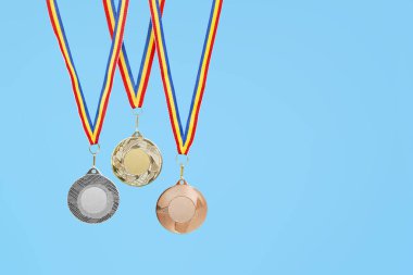 Mavi arka planda üç madalya, gümüş altın ve bronz madalya  