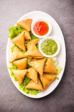cocktail mini triangle samosa made using patti or strip, popular home made snack from India