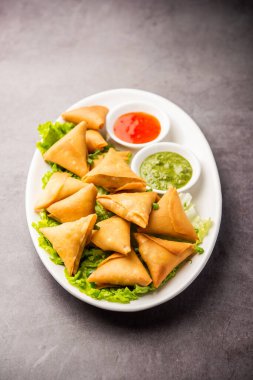 cocktail mini triangle samosa made using patti or strip, popular home made snack from India