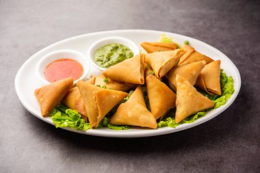 cocktail mini triangle samosa made using patti or strip, popular home made snack from India