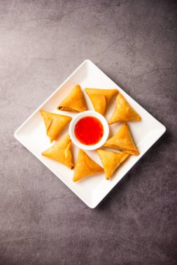 cocktail mini triangle samosa made using patti or strip, popular home made snack from India