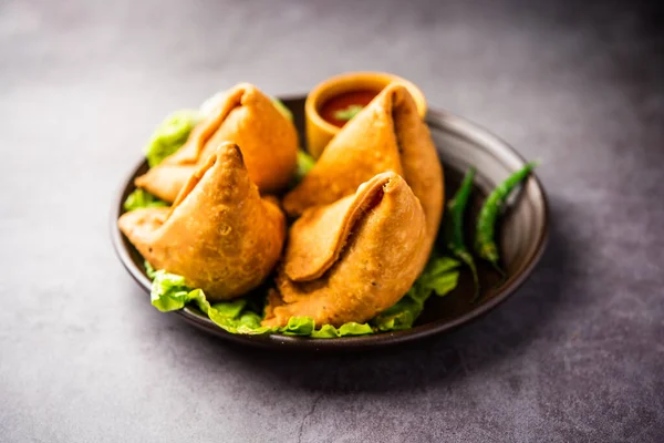 stock image samosa or singara. Indian fried or baked pastry with a savory filling, spiced potatoes, onion, peas